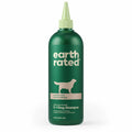 Green bottle of Earth Rated dog shampoo on a white background
