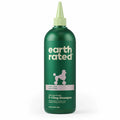 Green bottle of Earth Rated dog shampoo on a white background