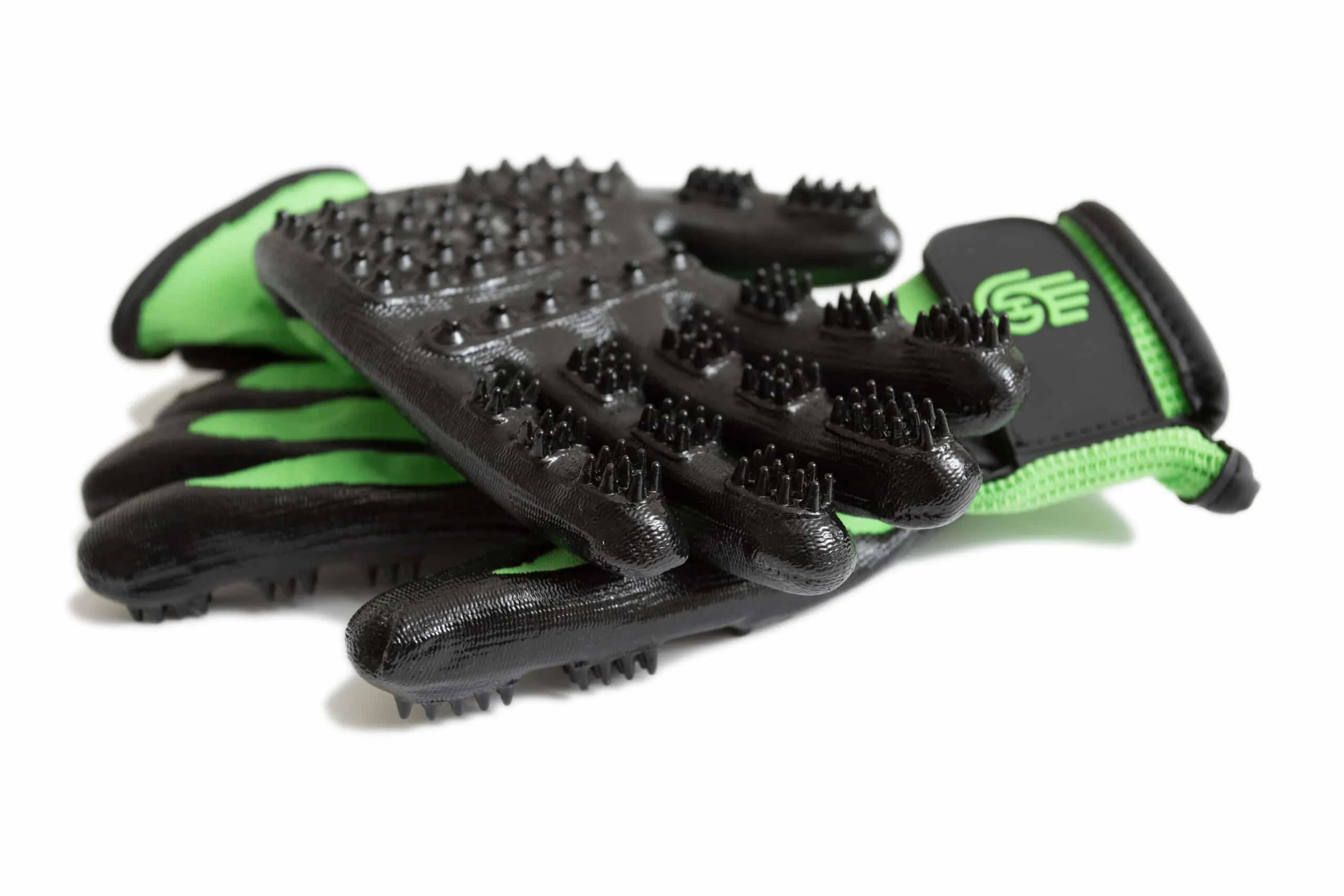 Black grooming gloves with bristle texture on a white background