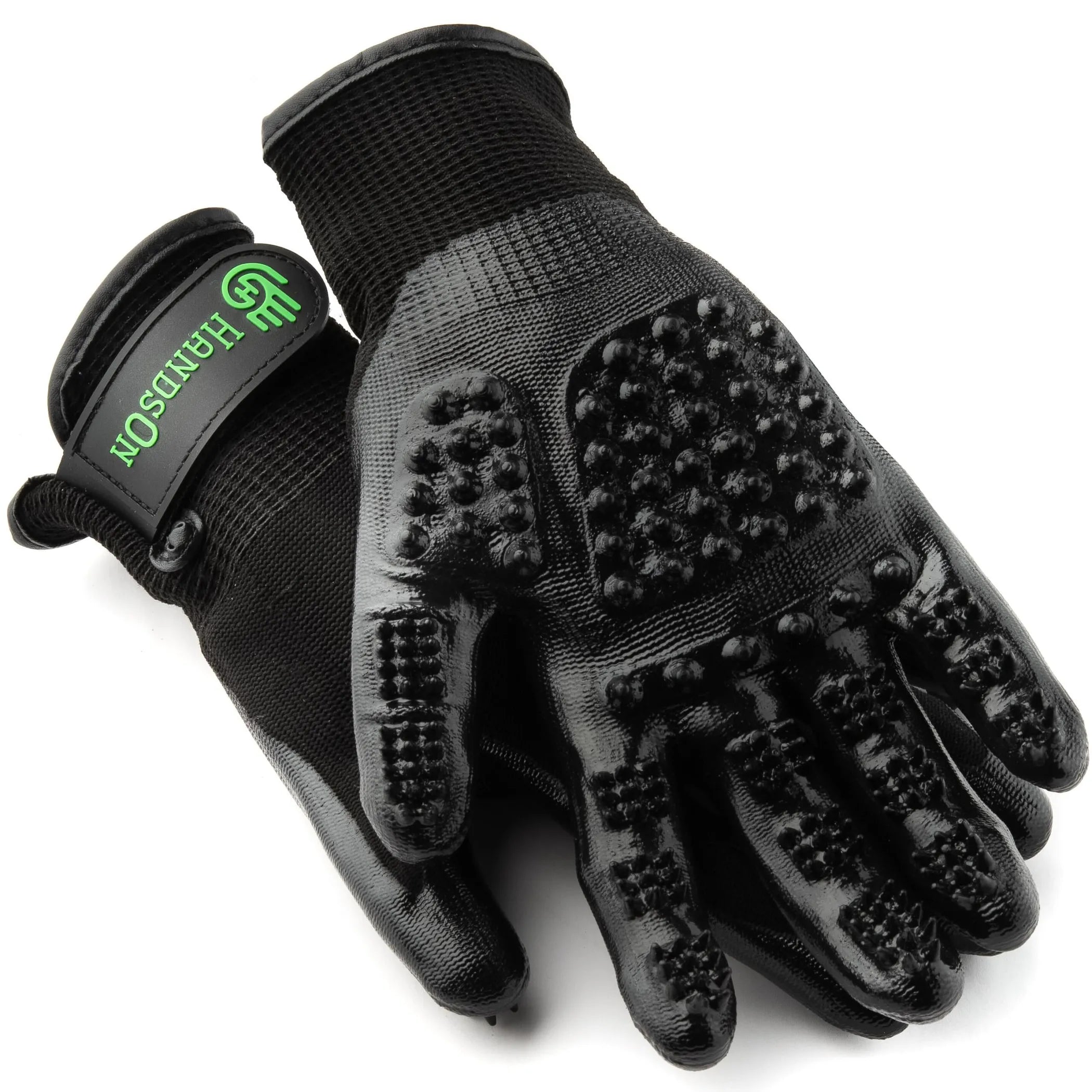 Black grooming gloves with textured surface on a white background