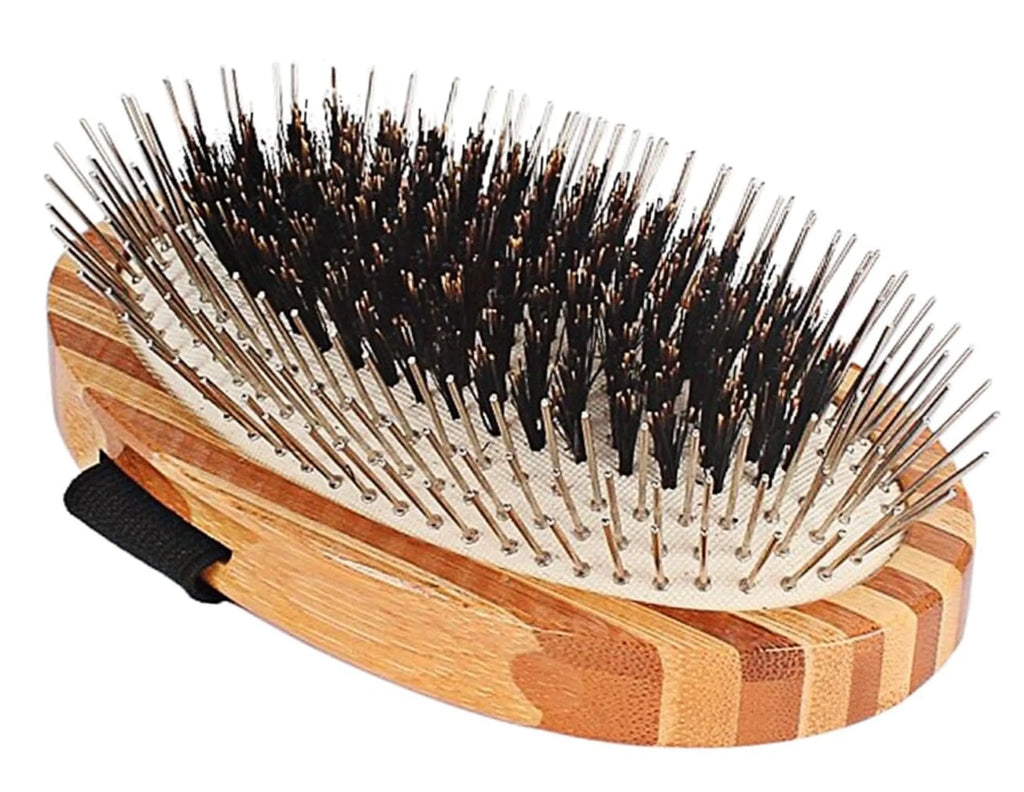 Wooden hairbrush with black bristles on a white background