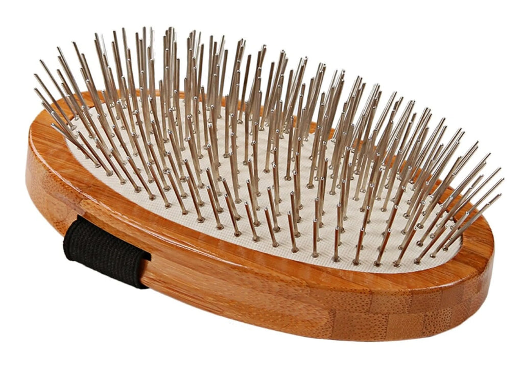 Wooden hairbrush with metal bristles on a white background