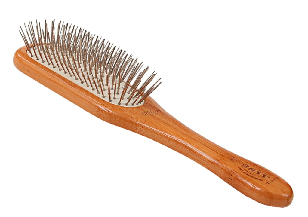 Wooden hairbrush with metal bristles on a white background