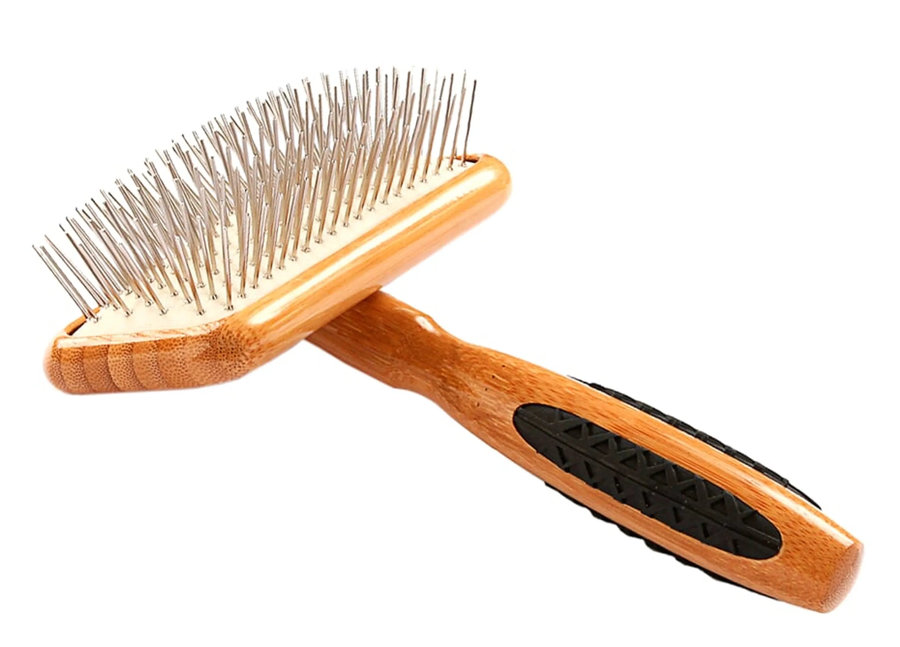 Wooden pet grooming brush with metal pins on a white background